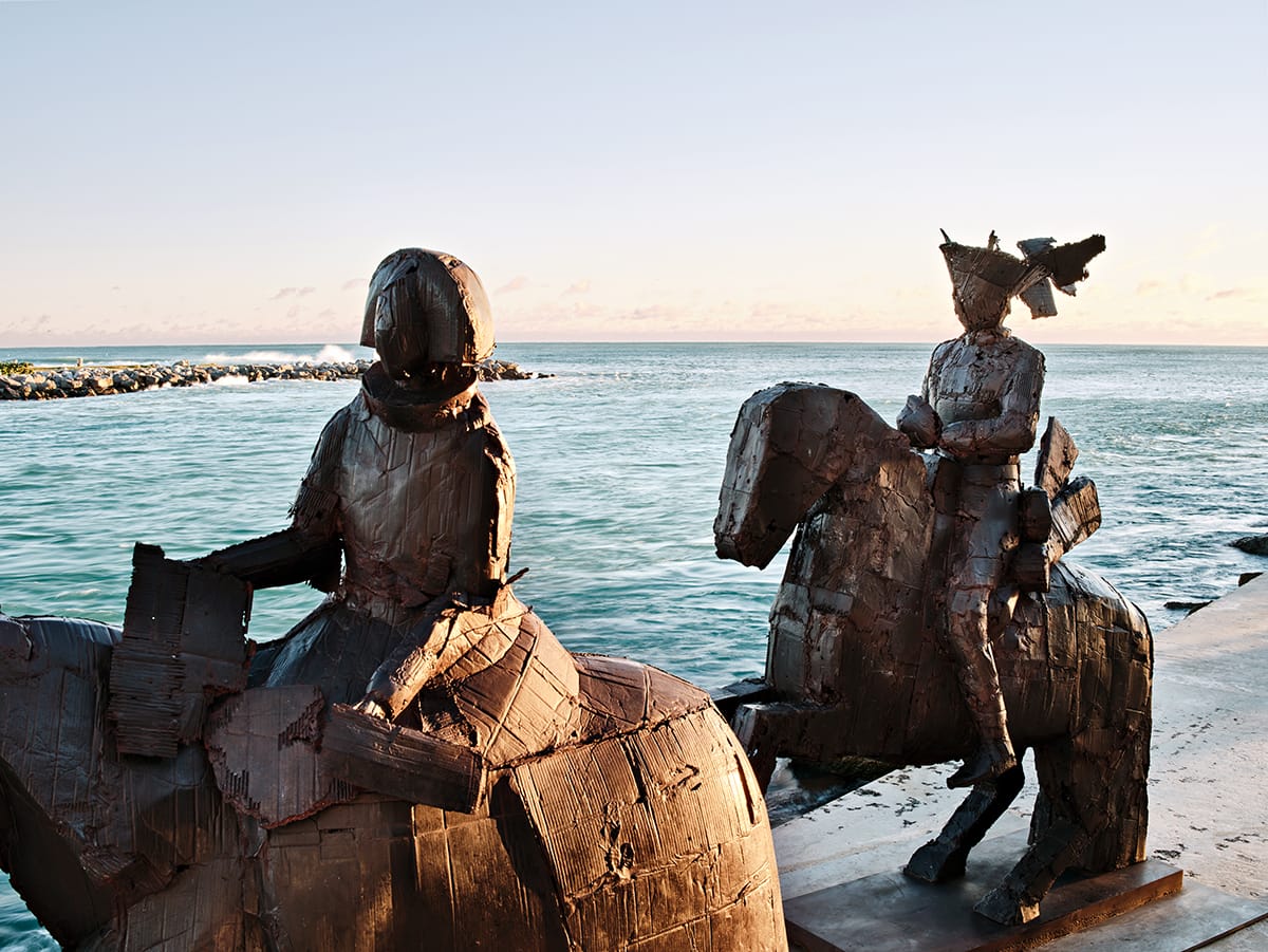 Sculptures of horses by the beach